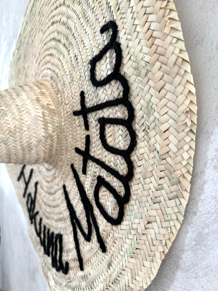 Embroidered straw hat size XL hung on the wall — family home decor