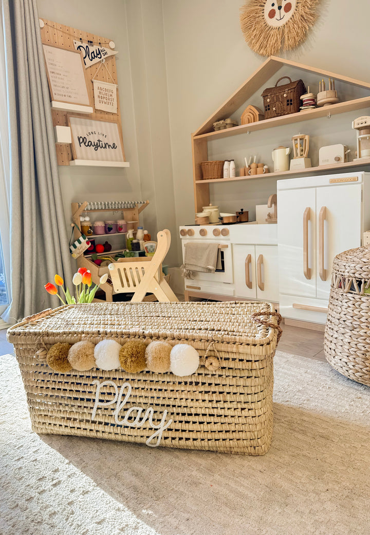 Detail of personalized name embroidered in wool on a Moroccan wicker basket.